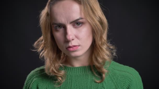 Closeup portrait of adult caucasian female looking at camera with serious and angry facial expression — Stock Video