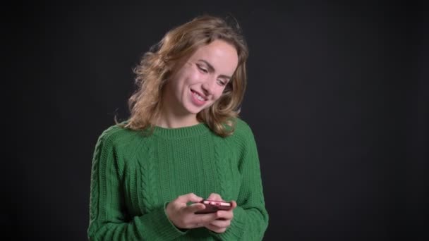 Närbild porträtt av vuxen kaukasiska kvinnliga surfar på telefonen framför kameran — Stockvideo