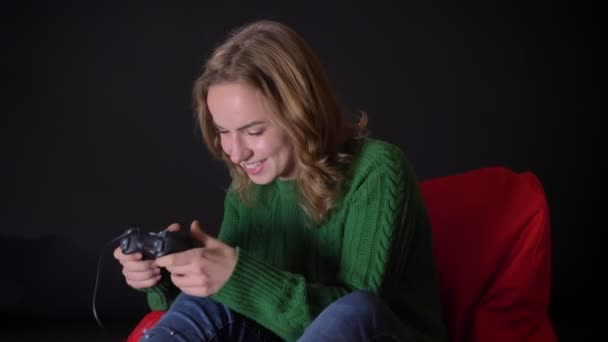 Closeup portrait of adult caucasian female playing video games with excitement indoors — Stock Video