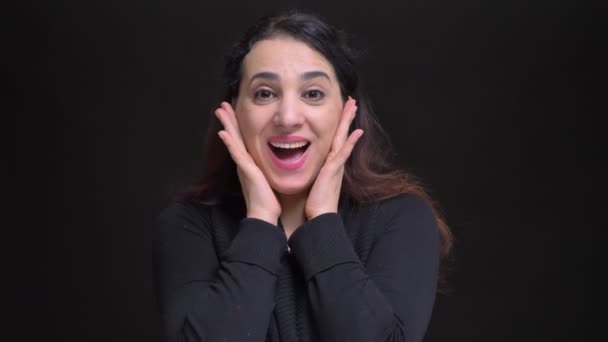Closeup portrait of young attractive caucasian female being surprised and getting excited while looking at camera — Stock Video