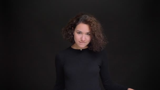 Closeup portrait of young charming caucasian girl showing a love sign and smiling while looking at camera — Stock Video