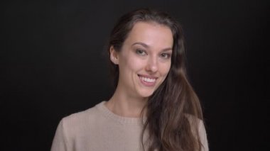 Esmer uzun saçlı beyaz kız kamera içine pozitif sürpriz siyah arka plan üzerinde gösterilen yakın çekim portre.