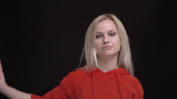Retrato de menina caucasiana de cabelos brancos jovem em camisola vermelha estranhamente dançando em fundo preto . — Vídeo de Stock