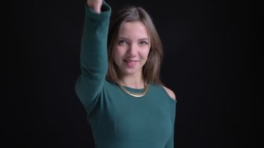 Gibi göstermek ve siyah arka plan üzerine saygı için mutlu parmak yukarı işareti işaret genç esmer beyaz kız portresi.