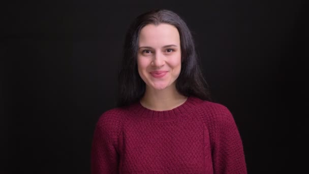 Closeup portrait of adult caucasian female with black hair smiling and laughing happily while looking straight at camera — Stock Video