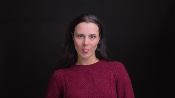 Closeup portrait of adult caucasian female playing a fool and making funny facial expressions while looking at camera — Stock Video