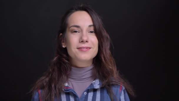 Nahaufnahme Porträt einer jungen schönen kaukasischen Frau, die in die Kamera lächelt und lässig zwinkert — Stockvideo