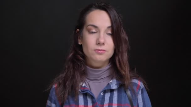 Closeup portrait of young attractive caucasian female waving her head in token of refusal while looking at camera — Stock Video