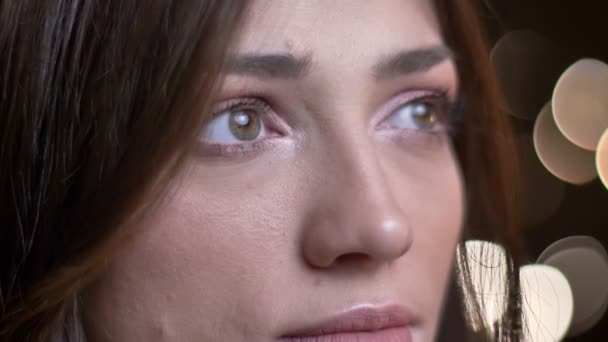 Closeup portrait of young beautiful caucasian female face with green eyes looking forward with a dreamy facial expression — Stock Video