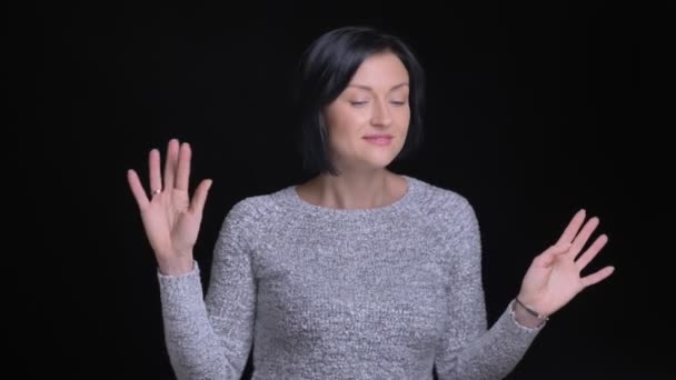 Closeup portrait of young beautiful caucasian female dancing and enjoying free time in front of the camera — Stock Video