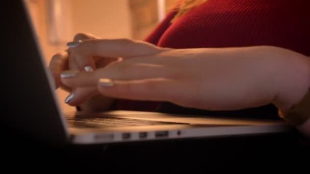 Closeup shoot by camera moving from the hands typing on the laptop indoors with a focus on keyboard — Stock Video