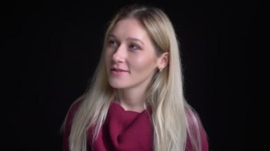 Genç güzel beyaz kadın kamera dönüm ve gülümsemeye düz bakarken gülümseyen closeup çekim