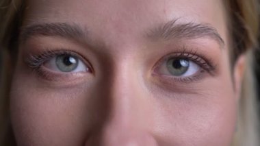 Kamera düz izlerken uzun sarışın saçlı genç çekici beyaz kadın yüz closeup ateş
