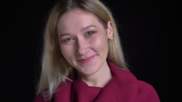 Retrato de close-up de jovem mulher branca atraente sorrindo feliz e posando na frente da câmera — Vídeo de Stock