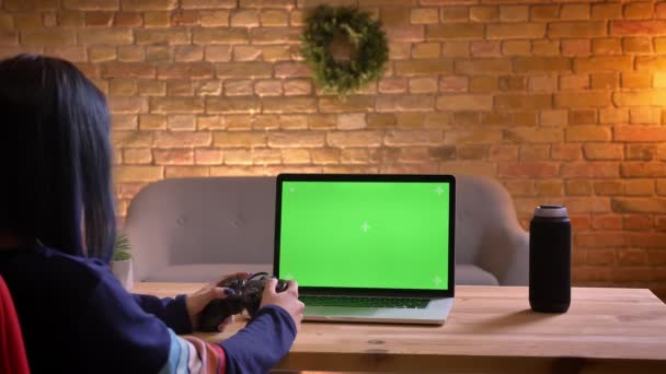 Zbliżenie strzelać z młodych atrakcyjnych kobiet wideo blogger grając w gry wideo za pomocą konsoli na laptopie z chroma zielony ekran i ukończenie poziomu szczęśliwy — Wideo stockowe