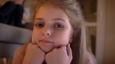 Yakın çekim ellerde yaslanmış ve ciddi arka plan üzerinde kız kardeşleri ile kameraya izlerken çok beyaz kız portresi.