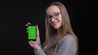 Portre genç çekici hipster telefonu kullanma ve kamera için yeşil ekran arka plan üzerine siyah izole ile gösterilen gözlüklü kadın ateş
