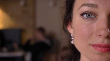 Closeup yarı-yüz yüz ifadesi işyeri kapalı üzerinde gülümseyen kamera düz seyir gözlü genç oldukça beyaz kadın yüzü ateş