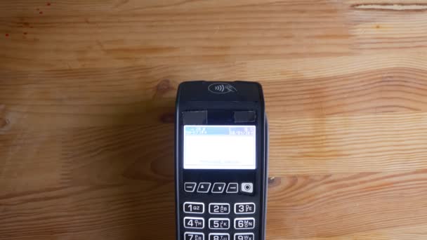 Closeup shoot of a payment terminal being used for payment by an app on the phone indoors. Hand being scanned by electronics — Stock Video