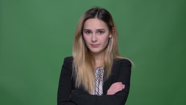 Closeup shoot of young attractive hipster caucasian female being unhappy and sad looking straight at camera with background isolated on green — Stock Video