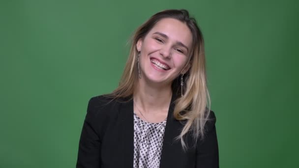 Closeup shoot of young attractive hipster caucasian female smiling cheerfully being happy and excited looking straight at camera with background isolated on green — Stock Video