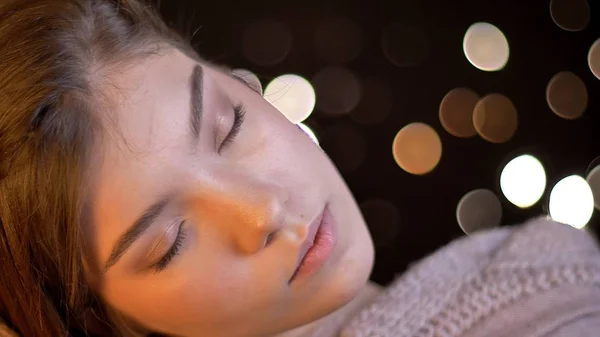 Close-up tiro de jovem feminino caucasiano morena feminino com os olhos fechados sendo alegre e relaxado com fundo bokeh — Fotografia de Stock