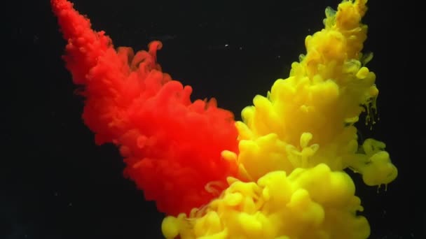 Cloud of red and yellow ink collision with paint cloud swirling isolated on black background. — Stock Video