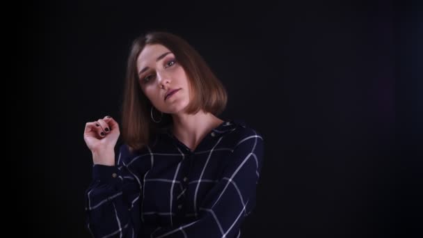 Closeup shoot of young pretty short haired female posing in front of the camera with background isolated on black — Stock Video