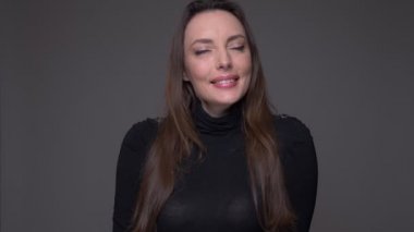 Gri üzerine izole arka plan ile kamera bakarak sevinç ve memnuniyet ile neşeyle gülümseyen yetişkin çekici kafkas kadın Closeup portre