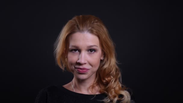 Closeup portrait of adult attractive redhead female smiling happily looking at camera with background isolated on black — Stock Video