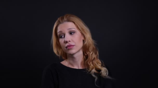 Closeup portrait of adult attractive redhead female being irritated and annoyed making an eye roll looking at camera with background isolated on black — Stock Video