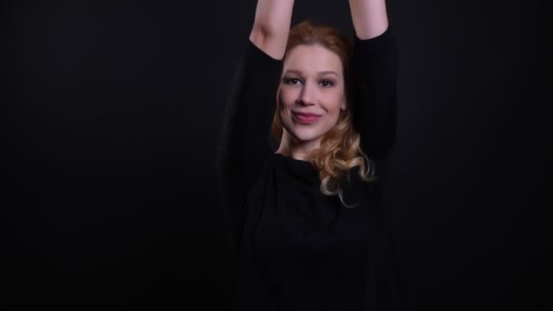 Closeup portrait of adult attractive redhead female dancing and having fun in front of the camera with background isolated on black — Stock Video