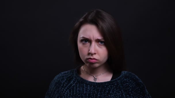 Close-up portret van volwassen mooie Kaukasische brunette vrouw boos en geïrriteerd kijken naar camera met achtergrond geïsoleerd op zwart — Stockvideo