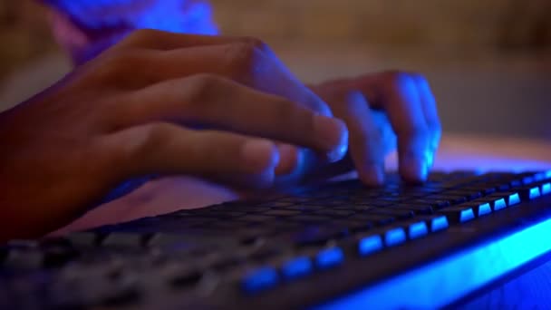 Closeup shoot of indian male hands typing on the computer indoors in a cozy apartment with neon light — Stock Video