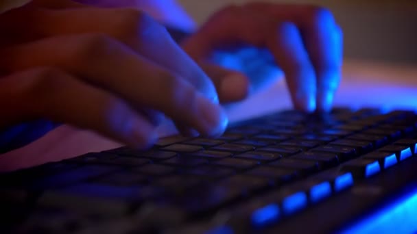 Closeup shoot of indian male hands typing on the keyboard indoors in a cozy apartment with neon light — Stock Video