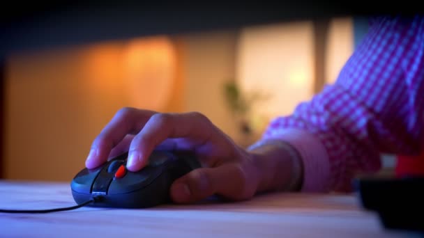 Closeup shoot of indian male bloggers hand using the computer mouse indoors in a cozy apartment with neon light — Stock Video