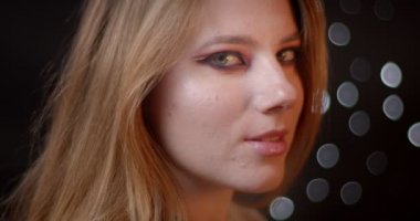 Bokeh arka planda kamera ile flört parlak ve canlı makyaj ile çekici zencefil modeli profil çekimi.