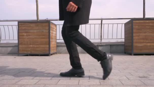 Closeup portrait of young attractive african american businessman performing a moonwalk on the street in the urban city — Stock Video