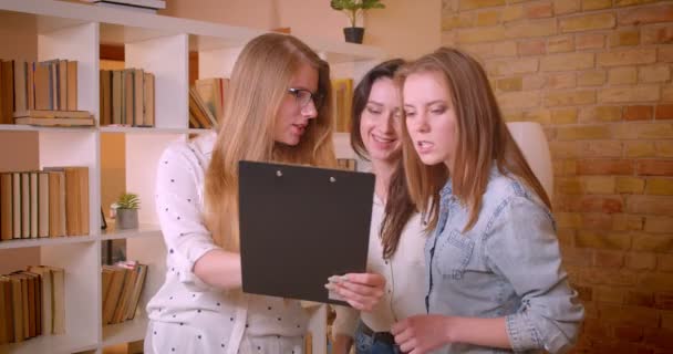 Closeup hajtás a fiatal vidám leszbikus pár beszél a női ingatlanügynök mintegy megvásárlása egy lakást — Stock videók