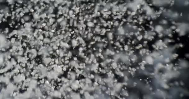 Closeup shoot of water being boiled with fizzy bubbles and background isolated on black — Stock Video
