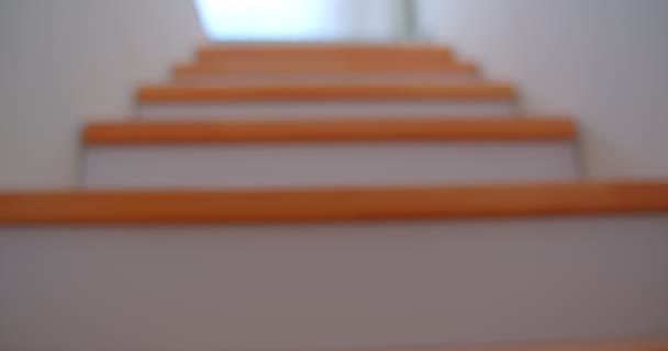 Closeup shoot of stairscase in the cozy apartment with modern interior being directed upstairs with blurred focus — Stock Video