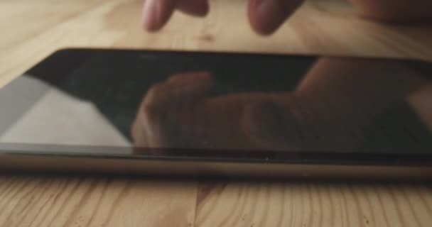 Tiro de perto de dedos masculinos rolando no telefone. Uso do dispositivo moderno na mesa de madeira dentro de casa — Vídeo de Stock