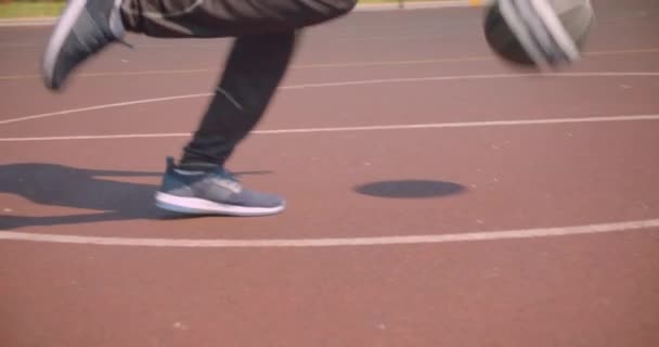 Retrato de jóvenes piernas masculinas deportivas guapos corriendo en la cancha en la ciudad urbana al aire libre — Vídeo de stock