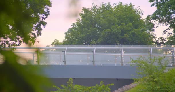 Vue urbaine prise de vue du pont moderne à l'extérieur avec jogging féminin athlétique actif à travers — Video