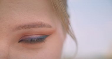 Kamera baştan çıkarıcı açık havada yanıp sönen göz görünümlü genç güzel beyaz kadın yüz closeup yarım yüz portre