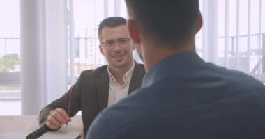Gözlüklü çekici işadamlarının işyerinde kapalı ofiste iş görüşmesi yaptığı closeup portresi