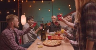 Rahat akşam eğlenceli bir partide mutlu bir şekilde alkol içme kutlayan pizza teslim ediliyor arkadaş çeşitli çok ırklı grup Closeup portre