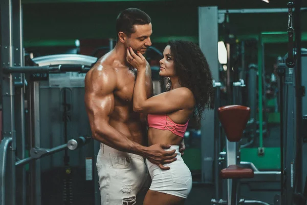 sportive life. fitness. gym. hot curly woman. handsome bodybuilder. muscular woman and man in gym. sportive couple.bodybuilding