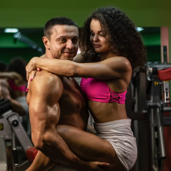 sportive life. fitness. gym. hot curly woman. handsome bodybuilder. muscular woman and man in gym. sportive couple.bodybuilding
