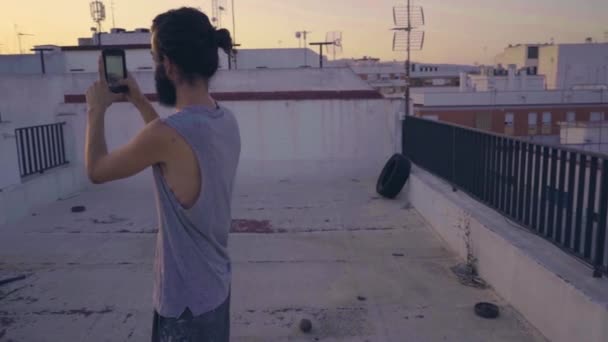 Man Taking Picture Smartphone Rooftop Sunset — Stock Video